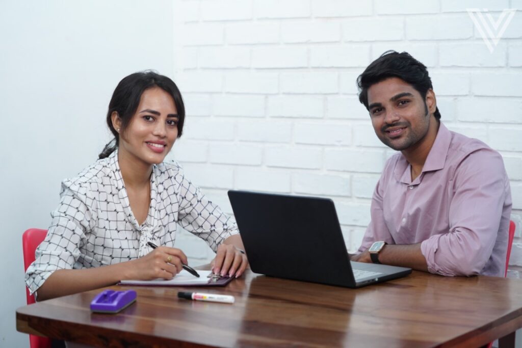 Colleagues working in the office and smiling