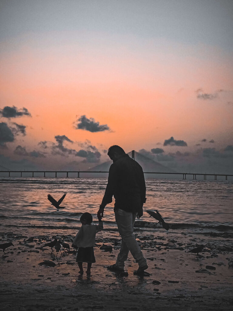 Man walking with a kid on a beach