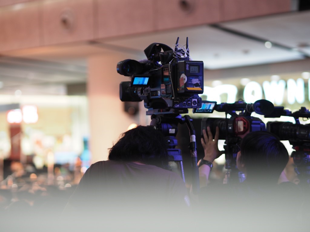 Man Standing with a Camera