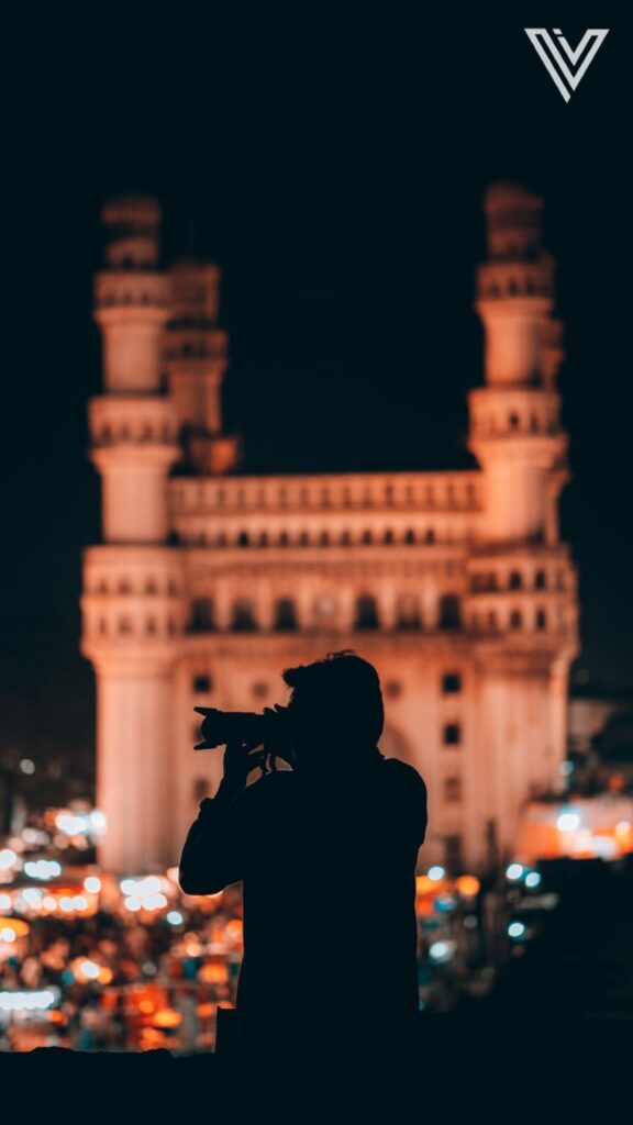 Man with camera in front of Charminar, Hyderabad