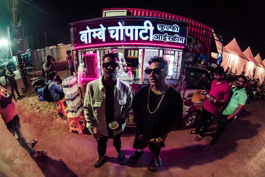 Two Men standing in front of a shop