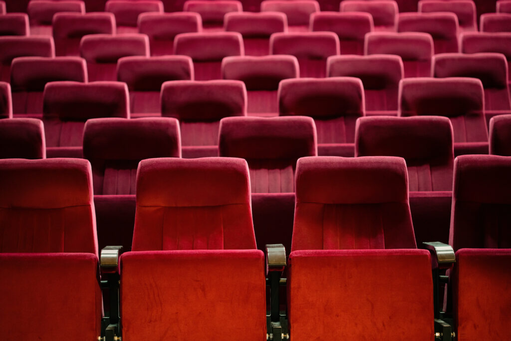 Empty cinema hall with red seats. Movie theatre